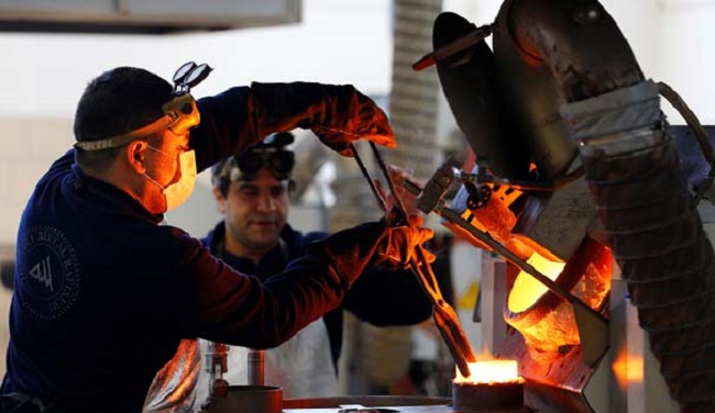 Melters work with fused gold during the production of ingots in Ahlatci Metal Refinery in the central Anatolian city of Corum, Turkey, May 11, 2017. Picture taken May 11, 2017. REUTERS/Umit Bektas